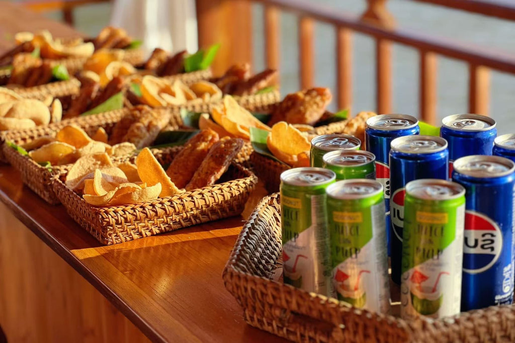 Baskets of snacks and drinks on a wooden surface